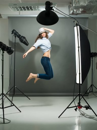 portrait-of-a-jumping-model-working-in-the-professional-photo-studio-SBI-325537178-min