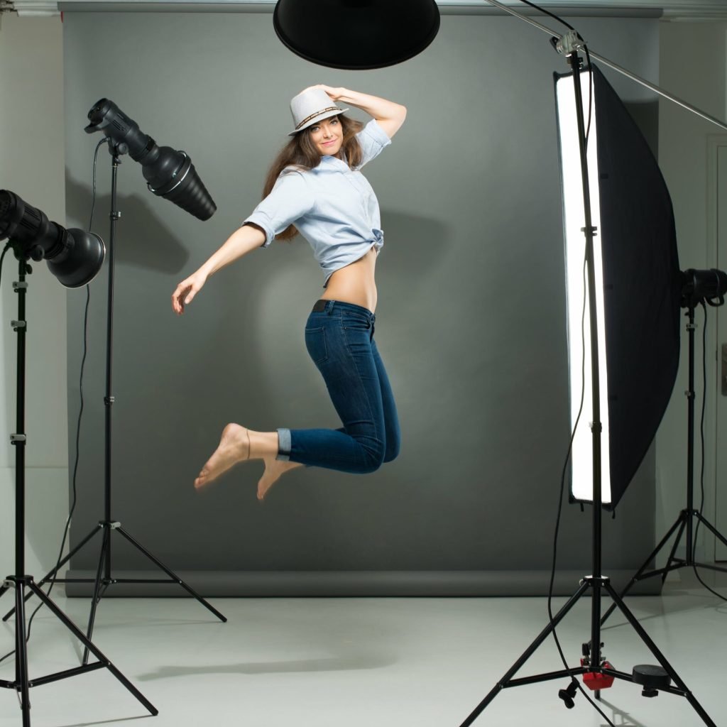 portrait-of-a-jumping-model-working-in-the-professional-photo-studio-SBI-325537178-min