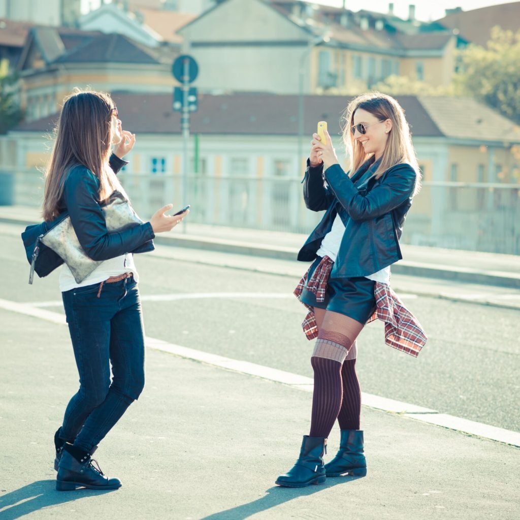 two-stylish-young-women-in-the-city-SBI-304357287-min